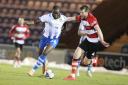 Strength - Colchester United striker John Akinde tries to hold off Doncaster defender Tom Anderson during his side's 4-1 defeat