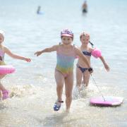 Splash - three youngsters at the City Beach in Southend yesterday (photo: Nick Ansell/PA Wire) Right: Packed - hundreds of sun seekers flocked to the beach to enjoy the weather