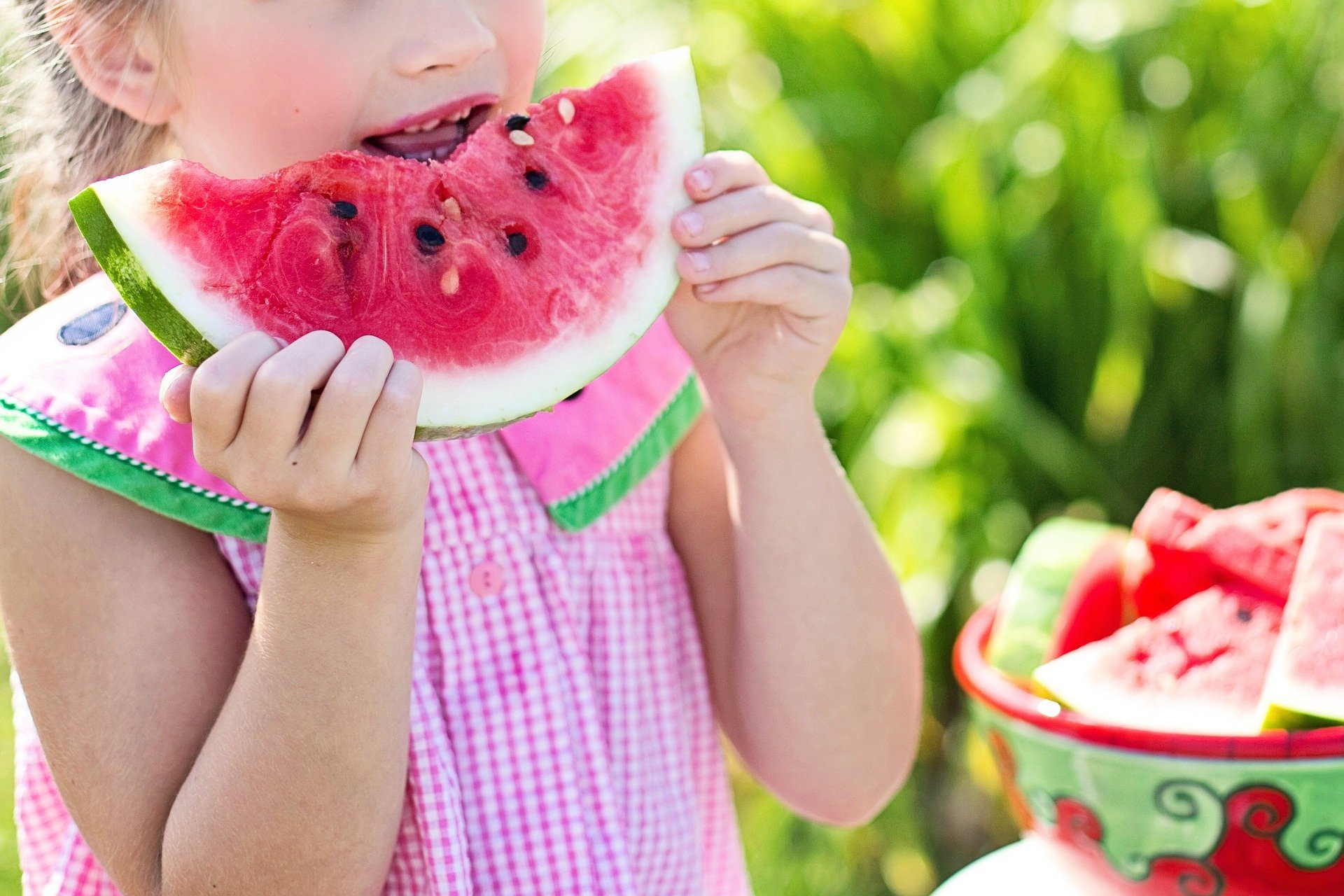 A child enjoys a piece of watermelon