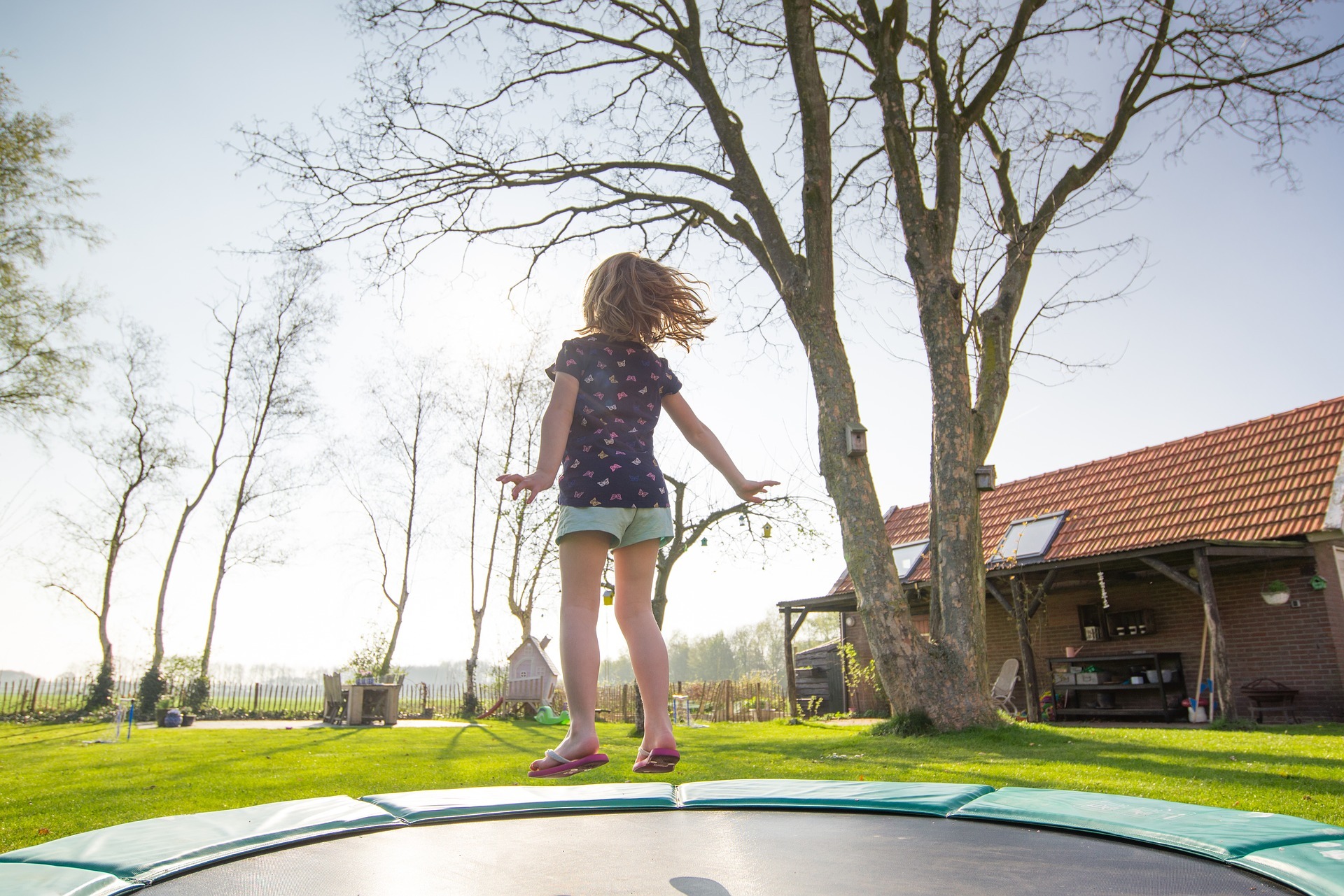 A child bounces on a trampoline 