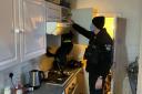 Essex Police PD searching kitchen in drugs raid