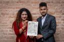 Same-sex couple Surendra Pandey, right, and Maya Gurung pose for a photograph with their marriage certificate (Niranjan Shrestha/AP)