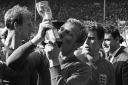 Bobby Moore plants an enthusiastic kiss on the World Cup trophy after England's victory over West Germany in the 1966 final