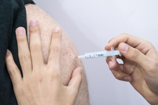 A booster coronavirus vaccine is administered at a Covid vaccination centre at Elland Road in Leeds, as the booster vaccination programme continues across the UK (Danny Lawson/PA)