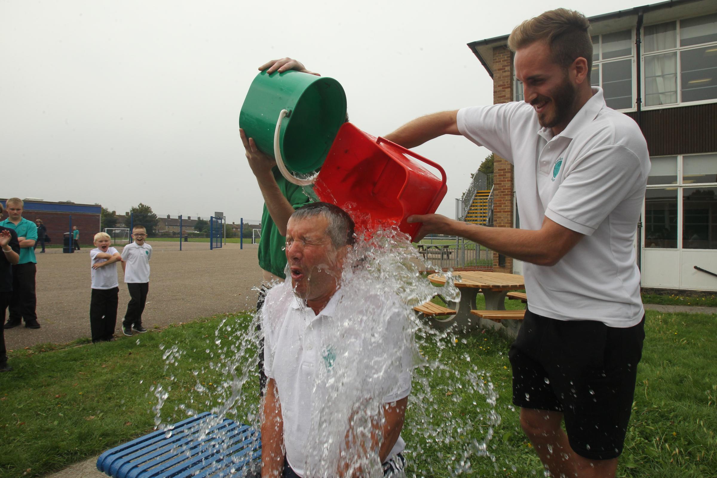 nigel brown Head teacher Gary Smith doing the ice bucket challenge with the children throwing the water over him, on Friday at Market Field School at the former Alderman Blaxill Site, Paxman Avenue Colchester.Also pictured pouring the water are,