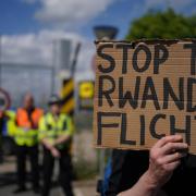 Demonstrators at a removal centre at Gatwick protest against plans to send migrants to Rwanda (PA)