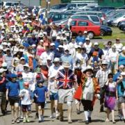 Starting the walk – John Baron, wearing a patriotic T-shirt, leads the fundraisers